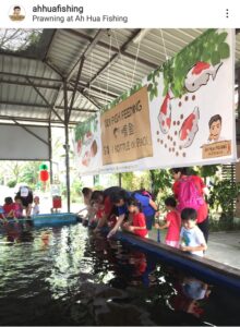 Preschool kids visiting and playing with fish in fish farm