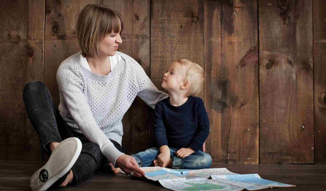 A mother playing with her toddler showing an engaging parenting style.