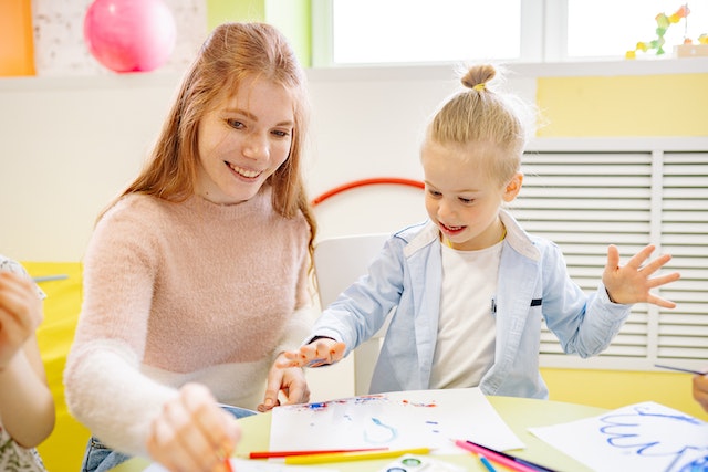 Happy child and preschool teacher-Good Qualities of a Preschool Teacher