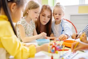 Preschool teacher playing with kids- Good characteristics of a preschool teacher