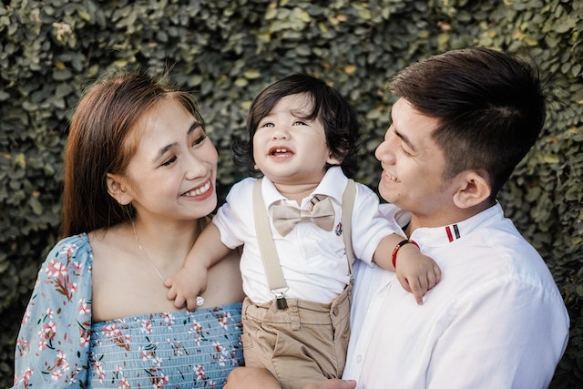 Image depicting a diverse couple, with the father being Indian, representing Asian parenting, and the mother being Western, representing Western parenting. They are engaged in a conversation, symbolizing the contrasting parenting styles and cultural influences between Asian and Western parenting approaches.