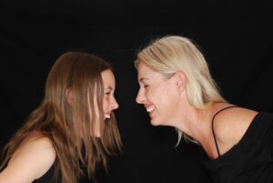 Mother and Daughter Facing and Smiling with Each Other - Toxic Mother
