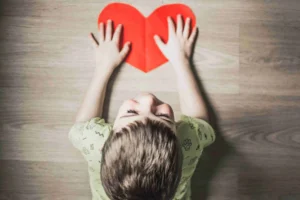 Boy Holding a Paper Heart - Emotionally Unavailable Parents