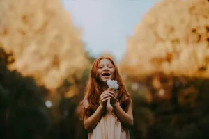 Happy girl holding flowers- What is self-esteem?