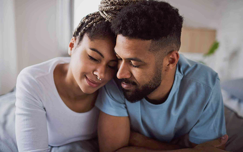 Couple resting their heads together, expressing love and emotional intimacy in their relationship.