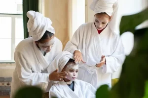 Kid applying skin care product with parent