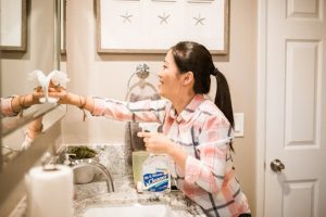 Maid cleaning toilet